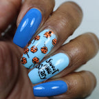 Blue nails, with orange pumpkins that are toffee apples