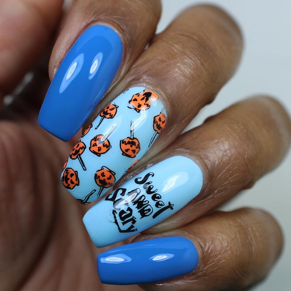 Blue nails, with orange pumpkins that are toffee apples